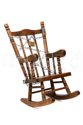 old wooden rocking chair captured with chain and padlock on white