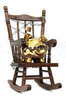 old wooden rocking chair and piggy bank captured with chain and padlock on white