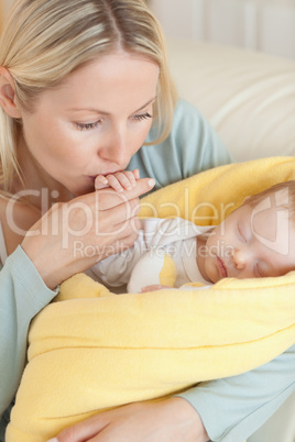 Close up of mother kissing her baby's hand