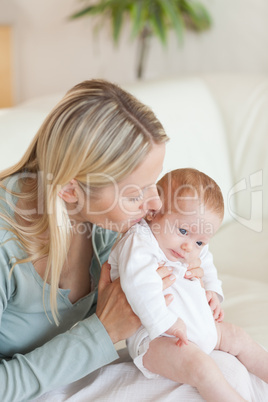 Mother on the sofa holding her baby