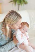 Mother on the sofa holding her baby