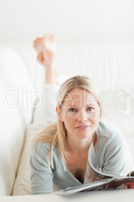 Woman with magazine on the sofa