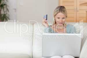Woman on the sofa booking holidays online