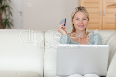 Woman on the couch booking holidays online