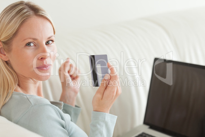 Back view of woman shopping online