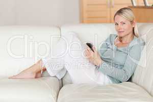 Woman on the sofa with her smartphone