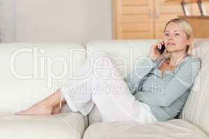 Woman sitting on the sofa listening to caller