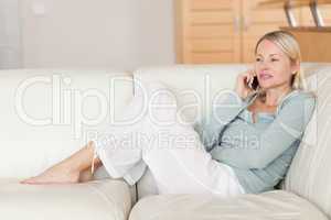 Woman sitting on the couch talking on the phone