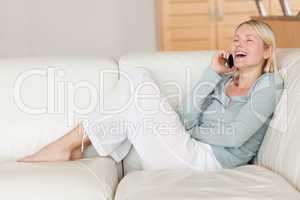 Woman enjoying phone call on the sofa