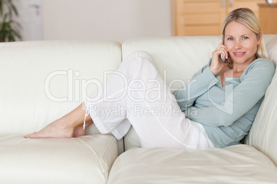 Woman sitting on the couch listening to caller