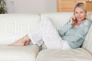 Woman sitting on the couch listening to caller