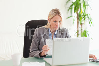 Businesswoman doing calculations