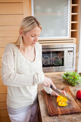 Side view of woman cutting vegetables