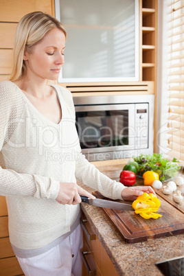 Side view of woman preparing vegetables for her salad