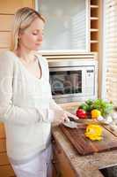 Side view of woman slicing vegetables for her salad