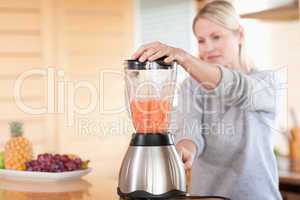 Side view of blender chopping fruits