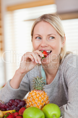 Close up of woman eating a strawberry