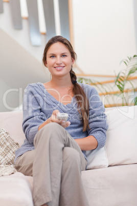 Portrait of a smiling woman woman watching TV