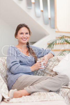 Portrait of a calm woman holding a cup of coffee