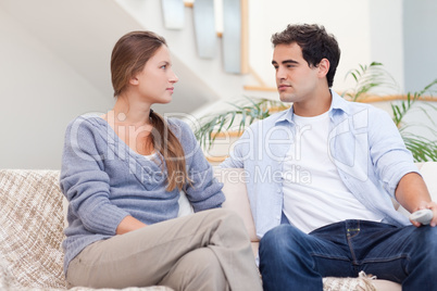 Couple having an argument while watching TV