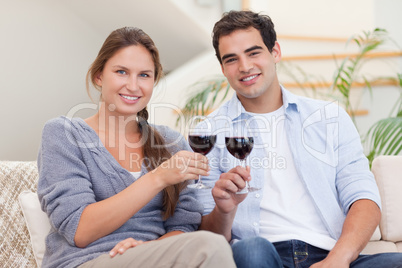 Young couple having a glass of red wine