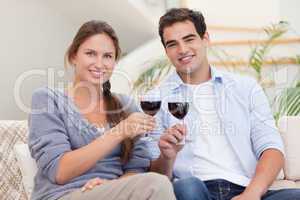 Young couple having a glass of red wine