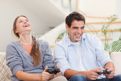 Happy couple playing video games