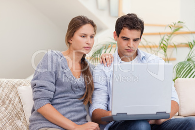 Couple using a laptop