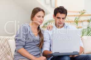 Couple using a laptop