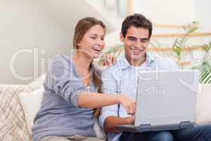 Happy couple using a laptop