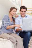 Portrait of a couple using a laptop