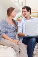 Portrait of a smiling couple using a laptop