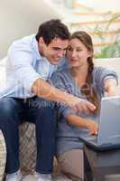 Portrait of a surprised couple using a laptop