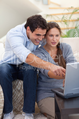 Portrait of a startled couple using a laptop