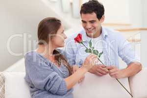 Man offering a rose to his girlfriend