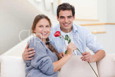 Young man offering a rose to his wife