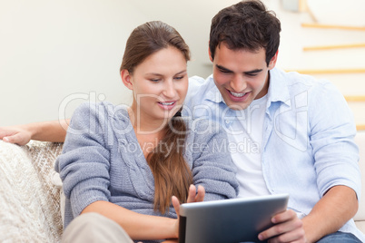 Happy couple using a tablet computer