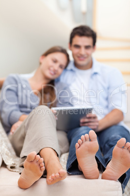 Portrait of a lovely couple using a tablet computer