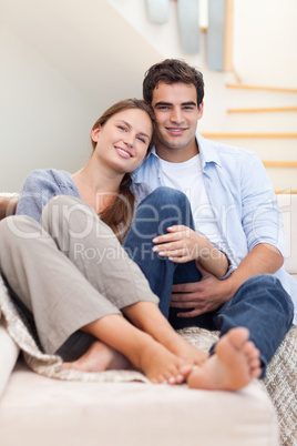 Portrait of a couple lying on a sofa