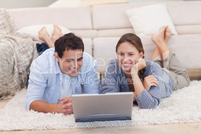 Couple watching a movie with a laptop