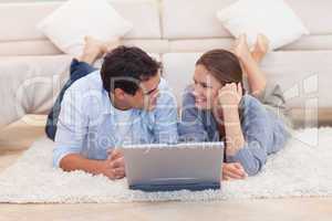 Couple posing with a laptop