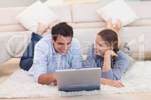 Smiling couple surfing on the internet