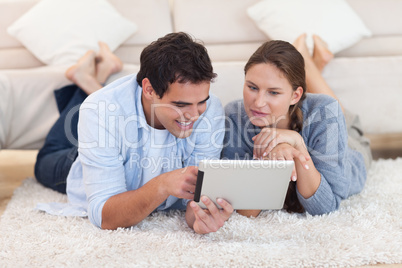 Radiant couple using a tablet computer