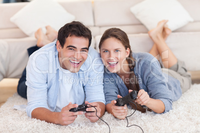 Delighted couple playing video games