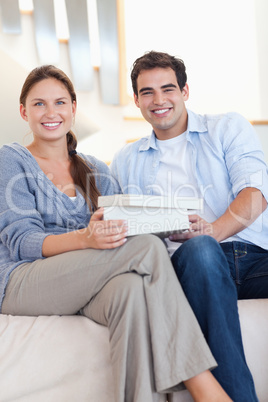 Portrait of a man surprising his fiance with a present