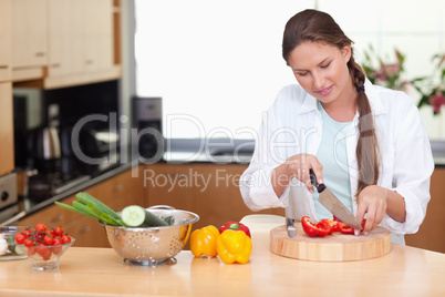 Young woman slicing a pepper