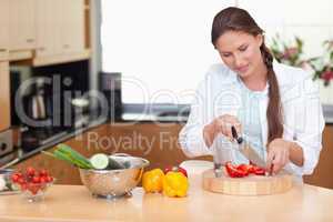 Young woman slicing a pepper