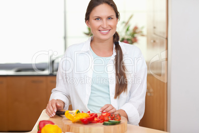 Lovely woman slicing a pepper