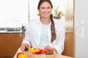 Lovely woman slicing a pepper