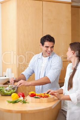 Portrait of a couple preparing a salad